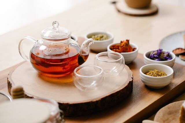 teapot with tea on a wooden board